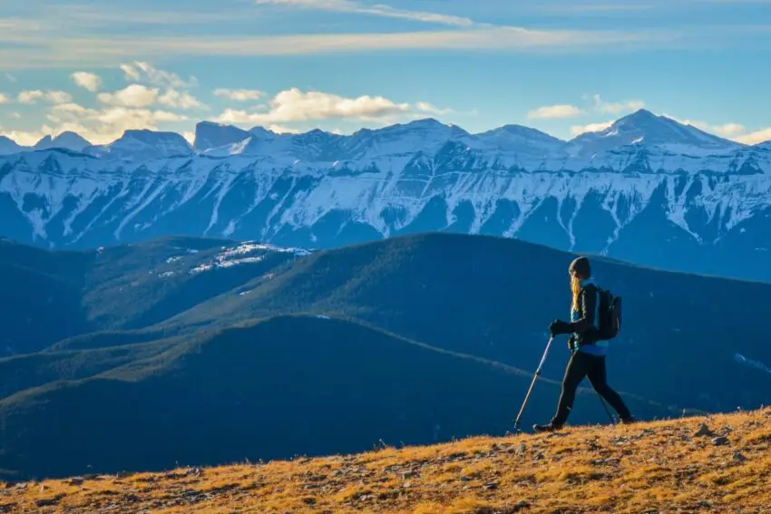 A woman hiker is delighting in the scenery of the Kananaskis Mountains.