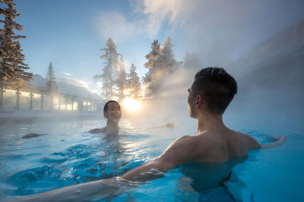 a couple in the upper hot springs in banff