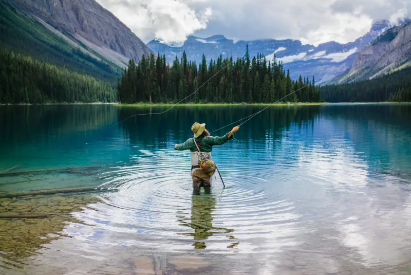 A man is fly fishing on Lake Marvel in a scenic shot