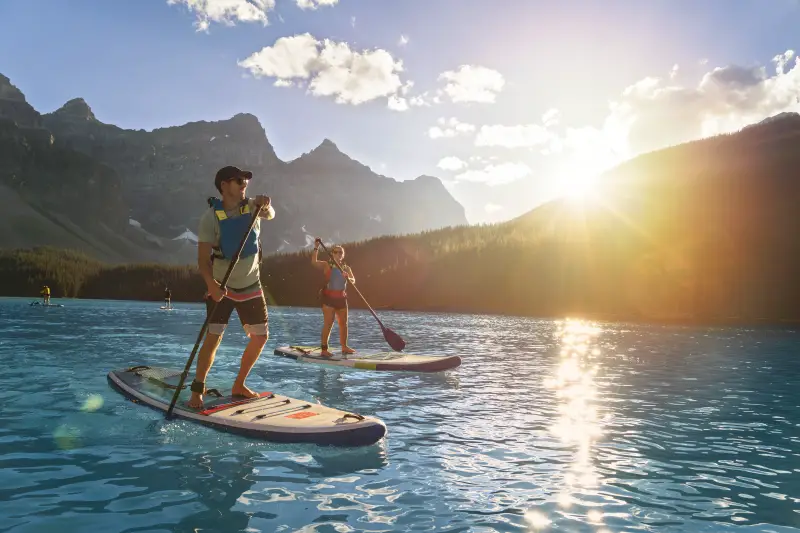 Tourists paddleboarding on Moraine Lake in Banff National Park