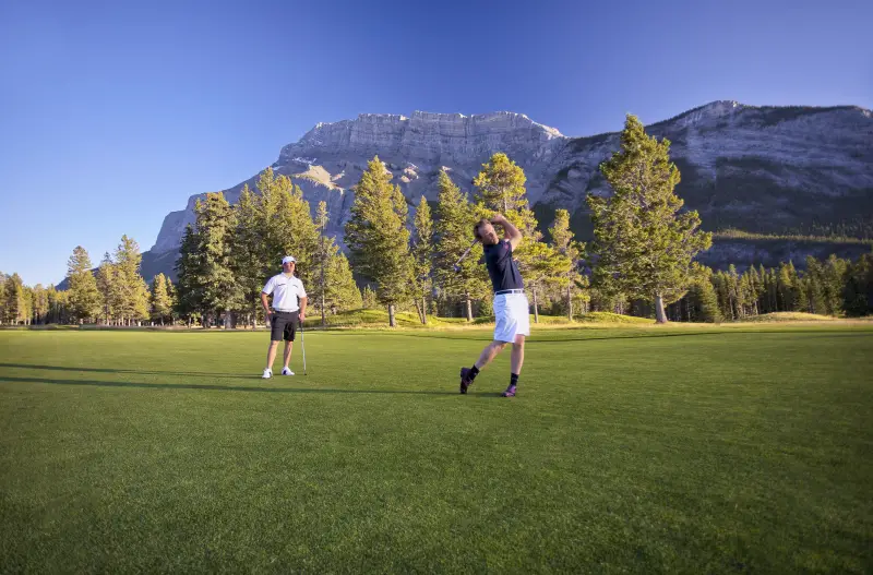 Two tourists playing golf at Banff Springs Golf Course