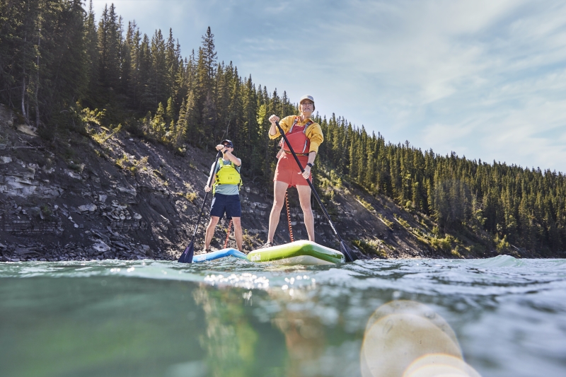 tourist couple paddleboarding on the Bow River